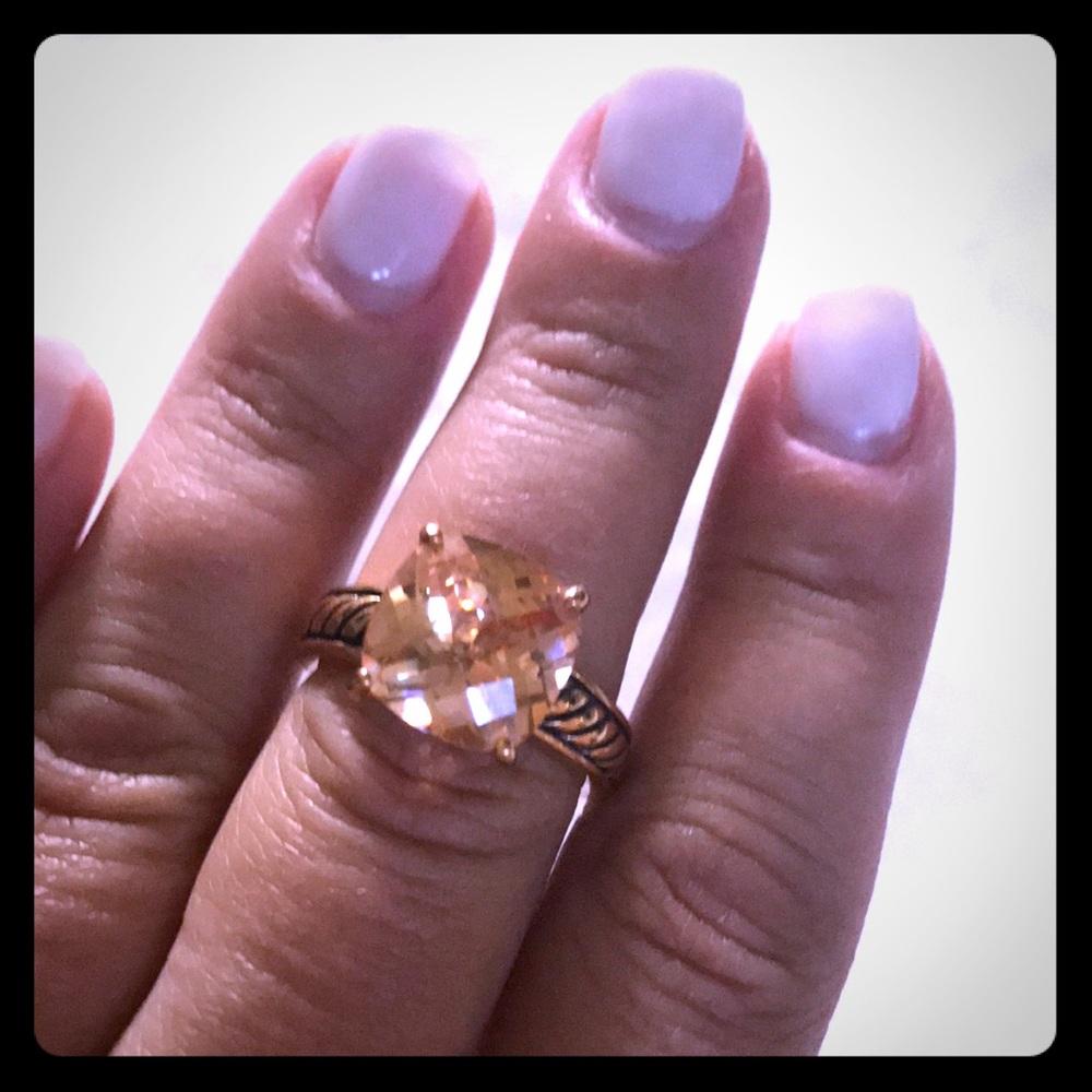 Gold ring with peach center stone